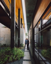 a couple of people standing next to each other near a building