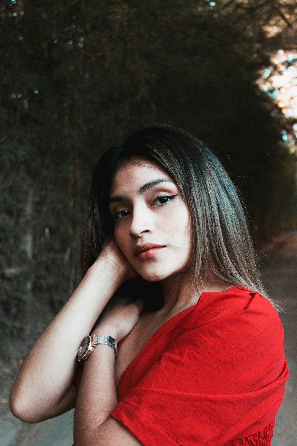 a woman in a red shirt posing for a picture