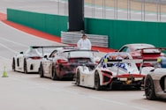 a group of race cars sitting on top of a race track