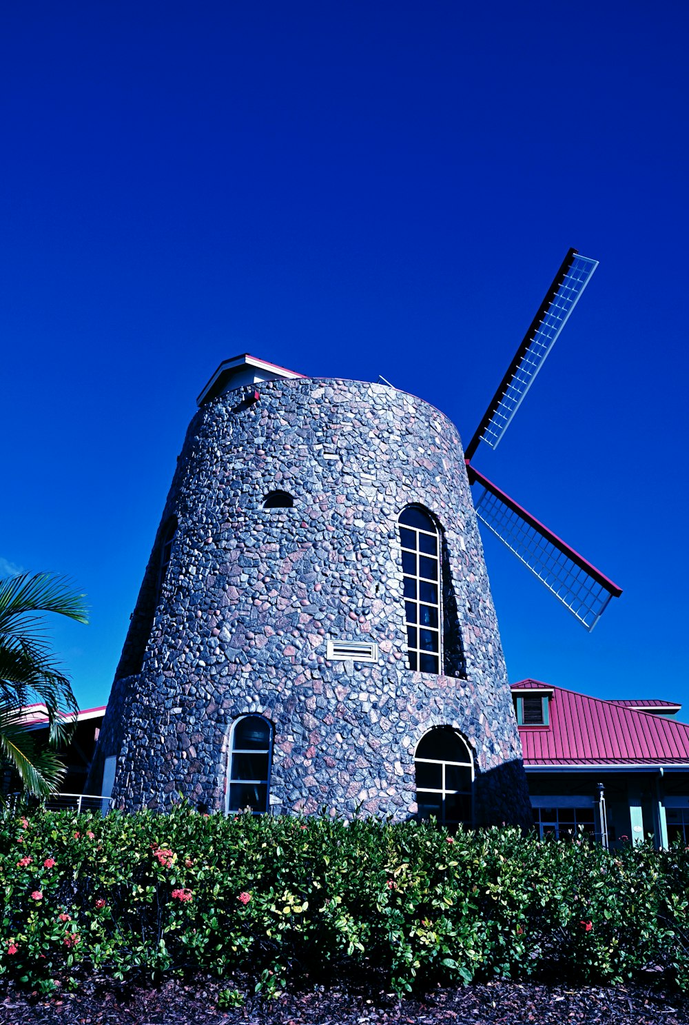 a stone building with a windmill on top of it