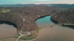 an aerial view of a lake surrounded by trees