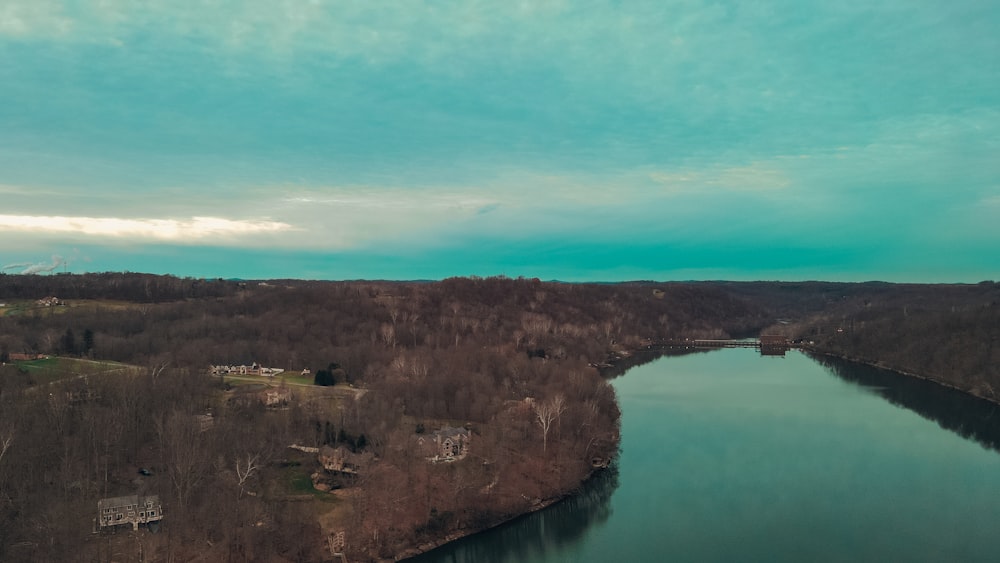 an aerial view of a lake surrounded by trees