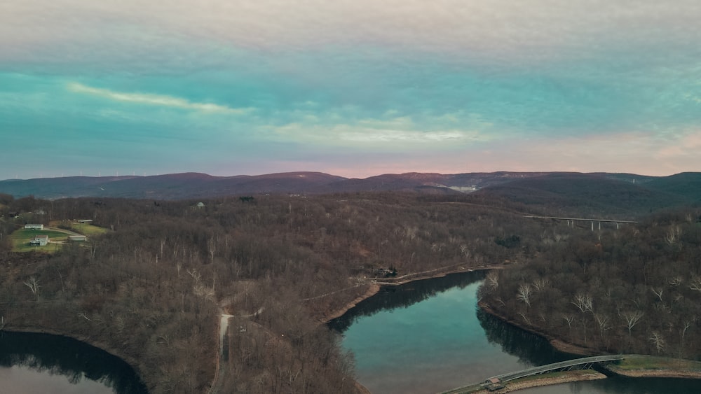 an aerial view of a lake surrounded by mountains