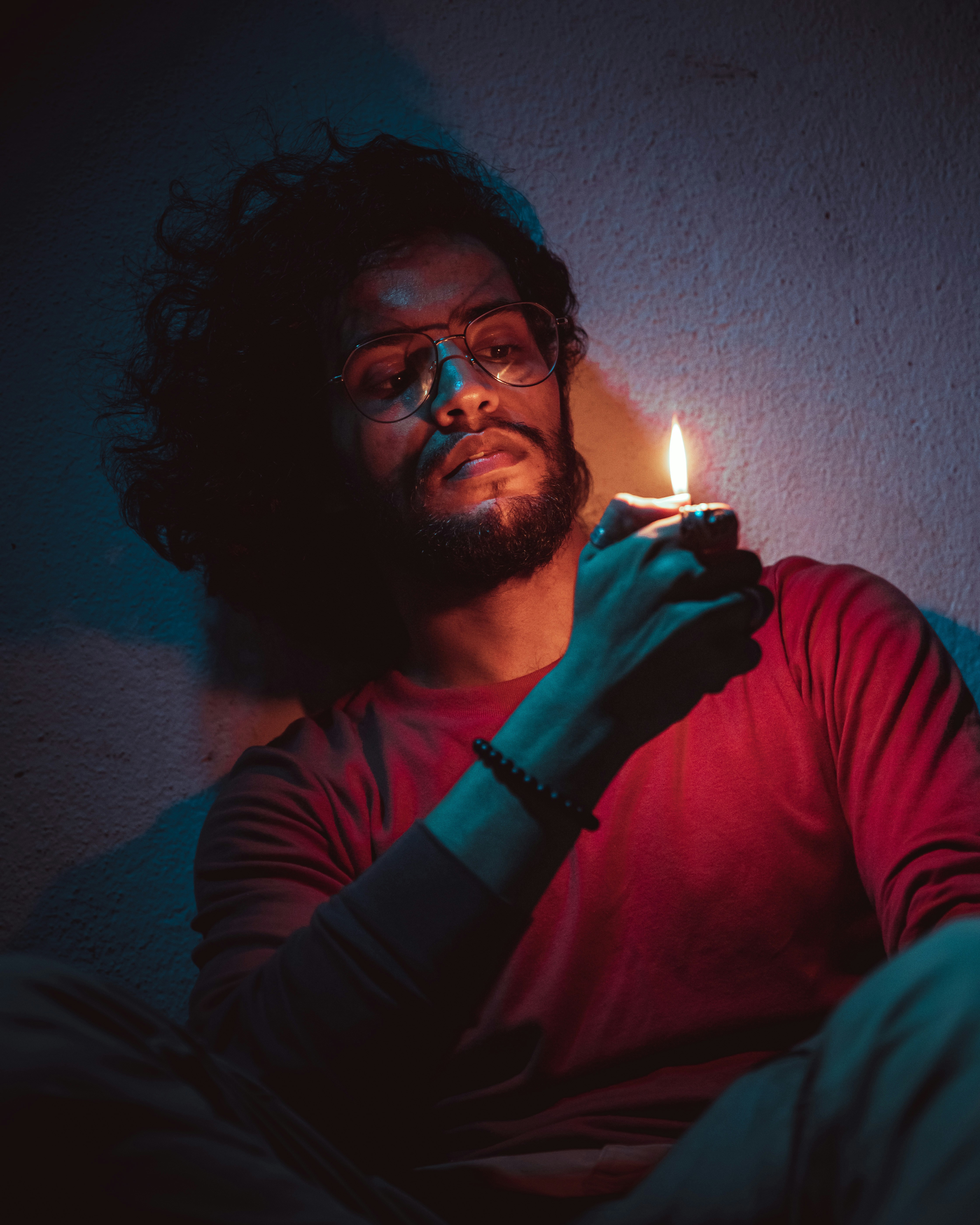 a man holding a lit candle in his hand