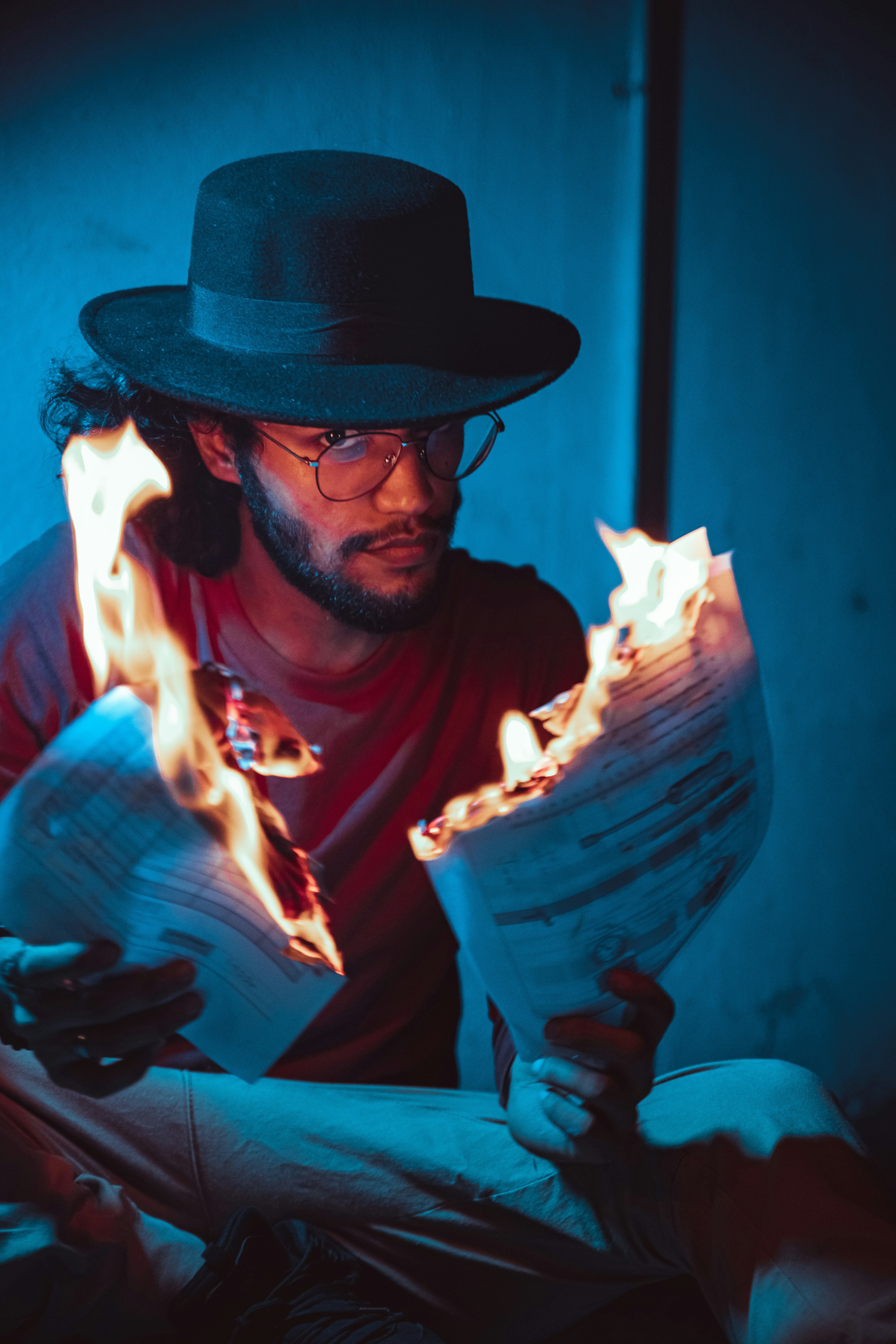 a man in a hat is reading a book