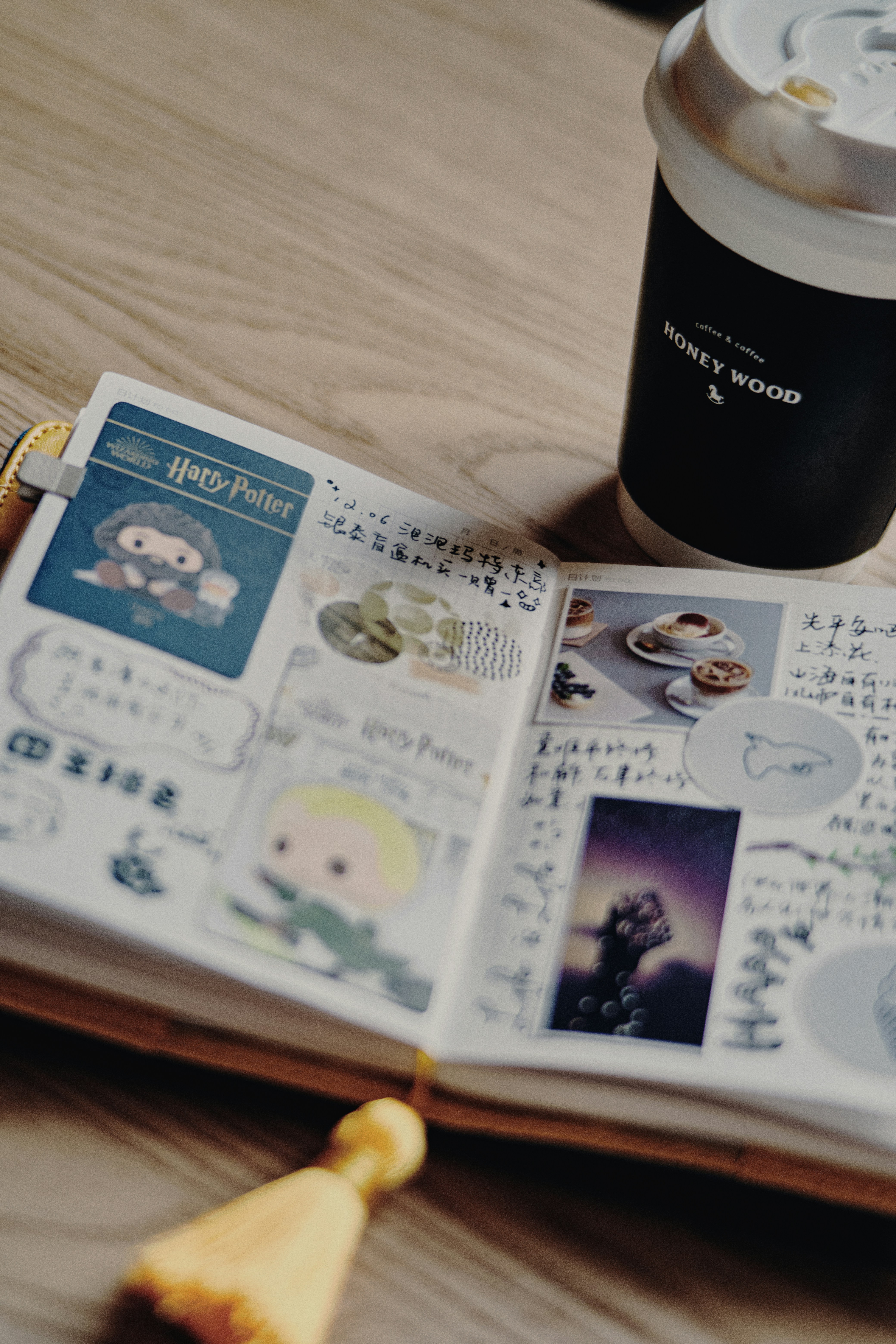 A decorated planner with coffee rests on a wooden table.