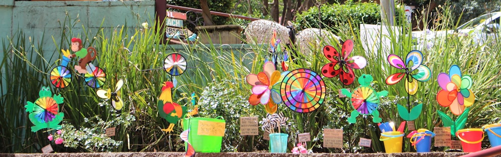 a bunch of colorful plastic flowers in a garden