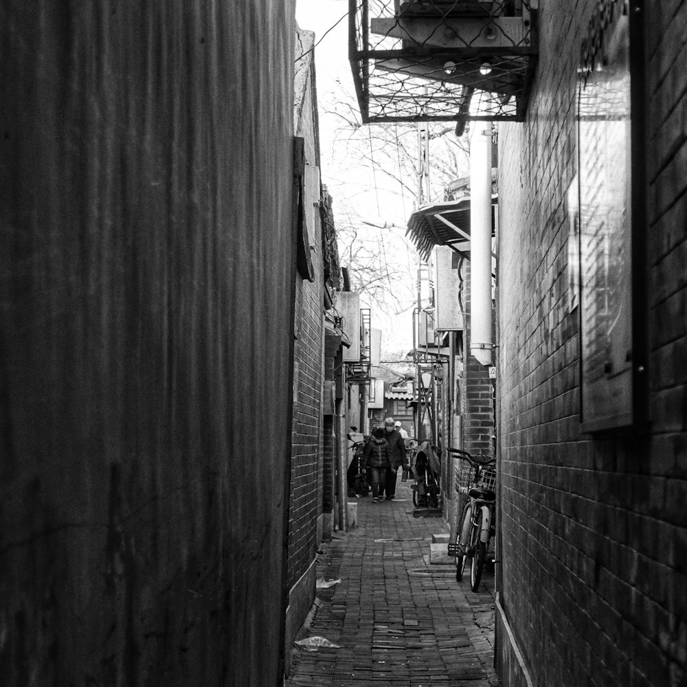 a black and white photo of a narrow alley way