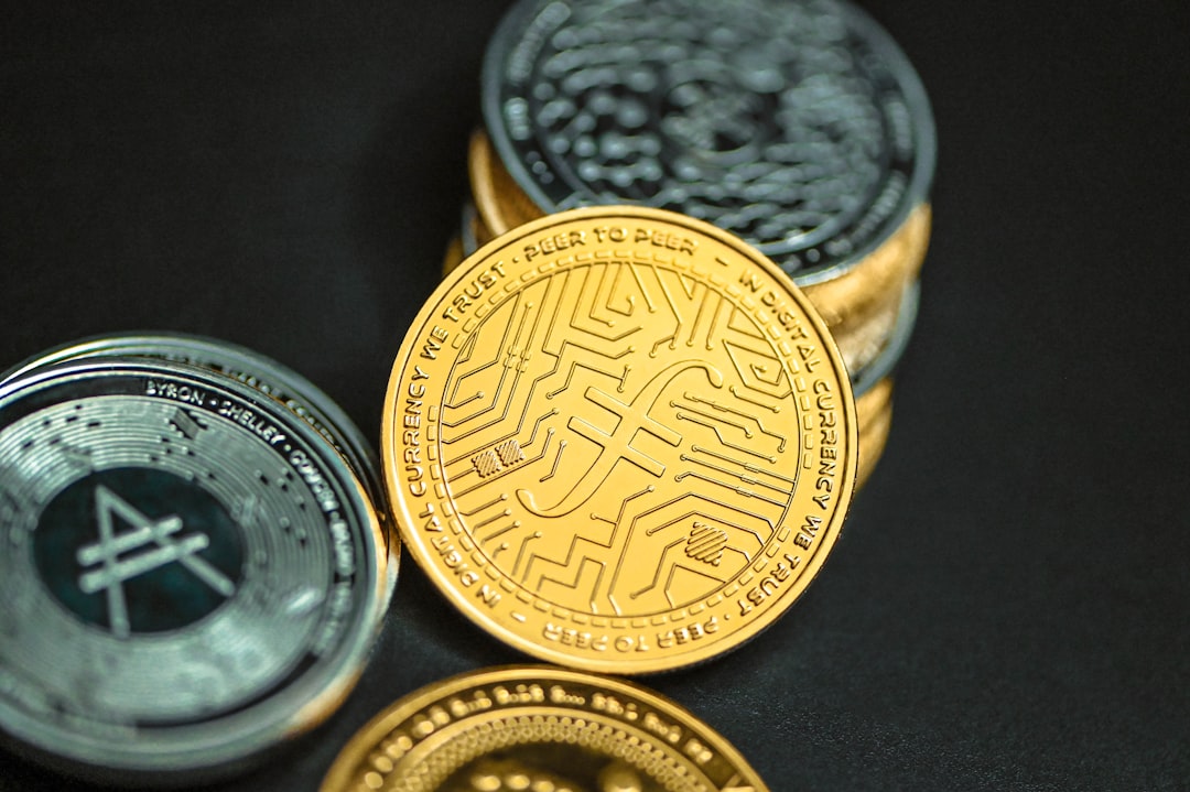 a close up of three different types of coins, Filecoin leaning on a stack of cryptocurrency coins