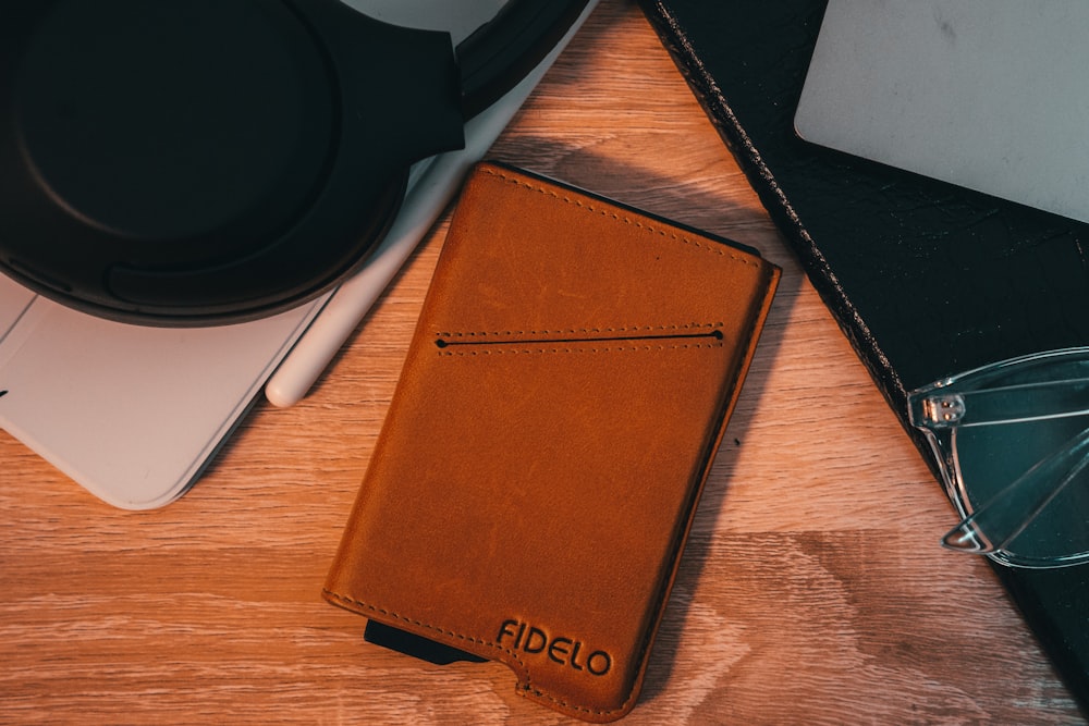 a brown leather case sitting on top of a wooden table