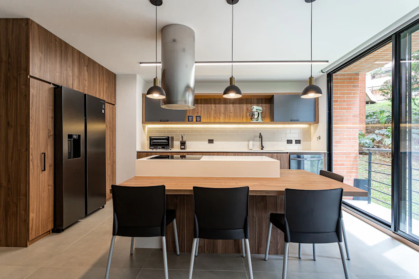 a kitchen with a table and chairs and a refrigerator