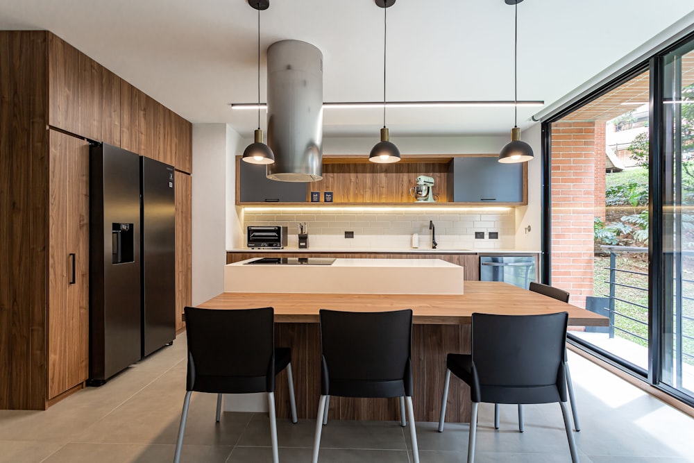 a kitchen with a table and chairs and a refrigerator