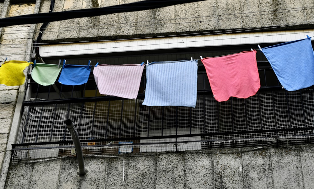 a row of colorful towels hanging on a clothes line