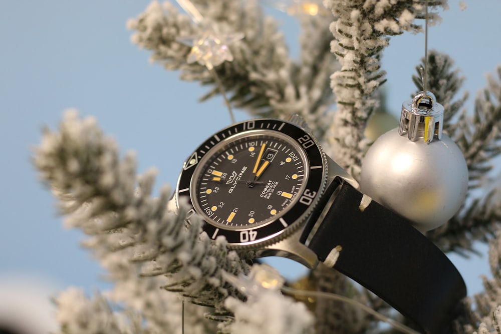 a watch is hanging from a christmas tree