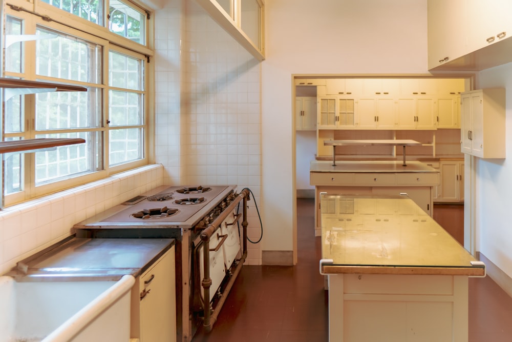 a kitchen with a stove top oven next to a window