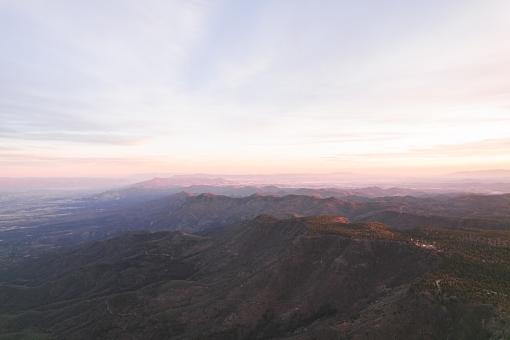 a scenic view of a mountain range at sunset