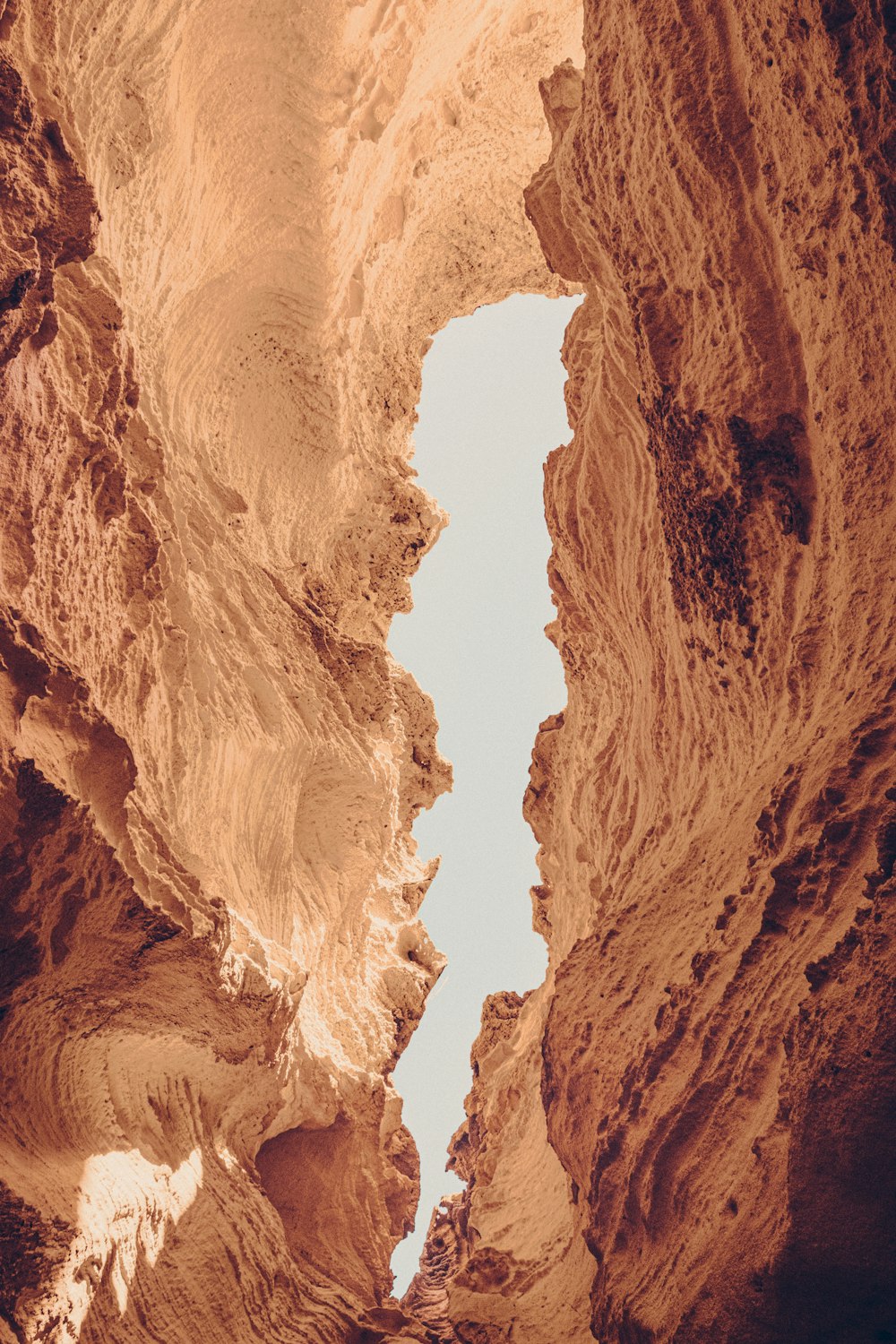 a view of a narrow canyon with a sky in the background