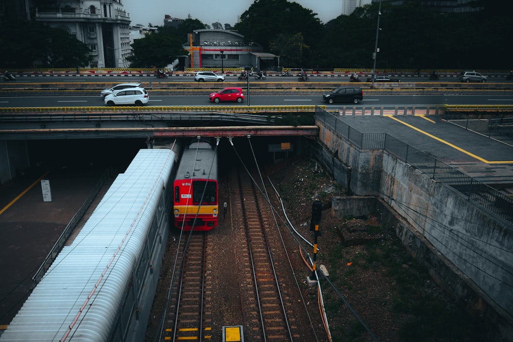 a red and yellow train traveling down train tracks