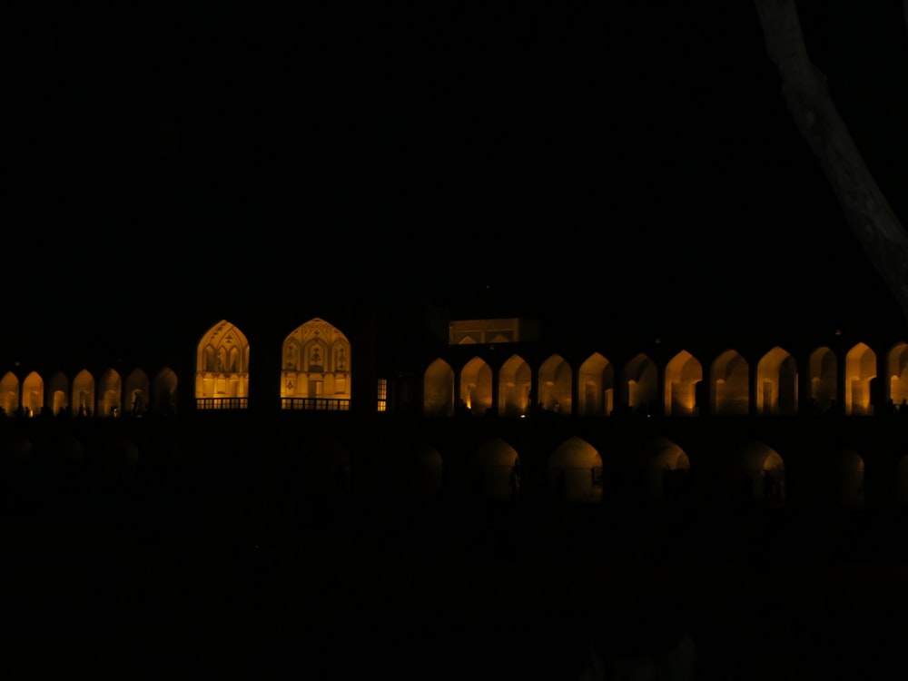 a row of buildings lit up at night