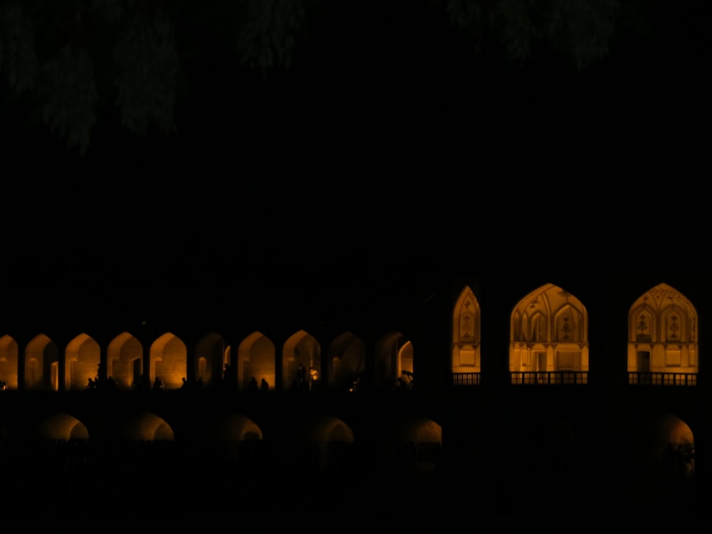 a group of arches lit up in the dark