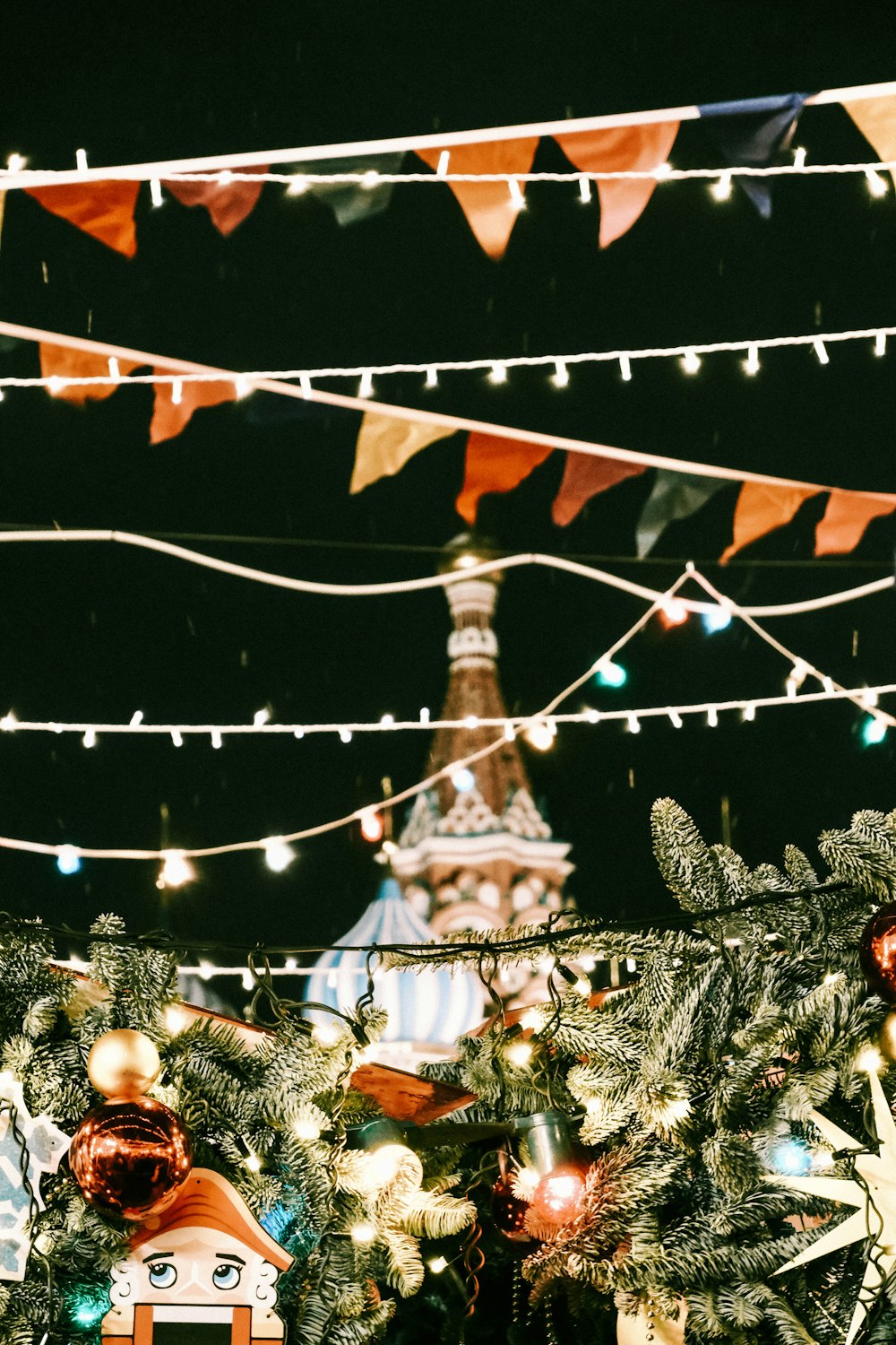 a christmas tree with a clock tower in the background