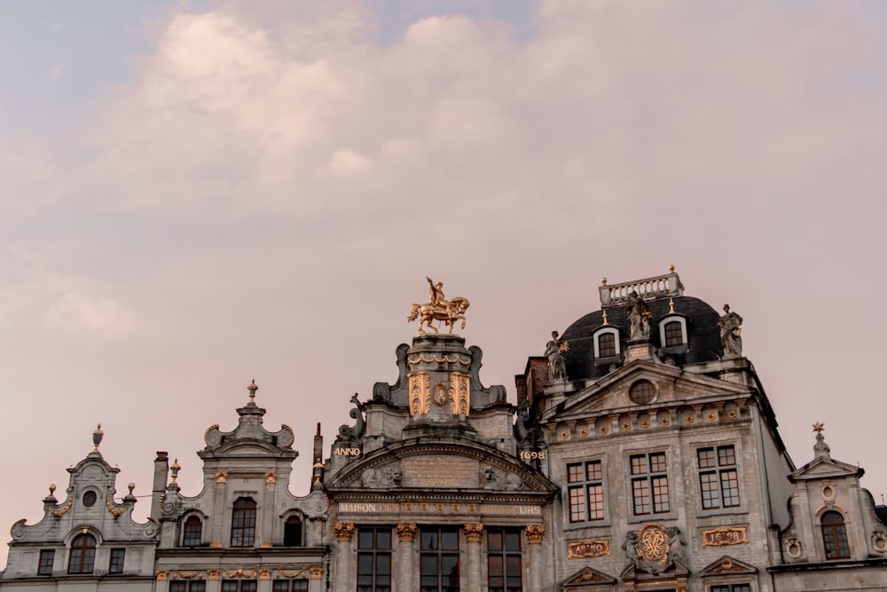 a large building with a statue on top of it