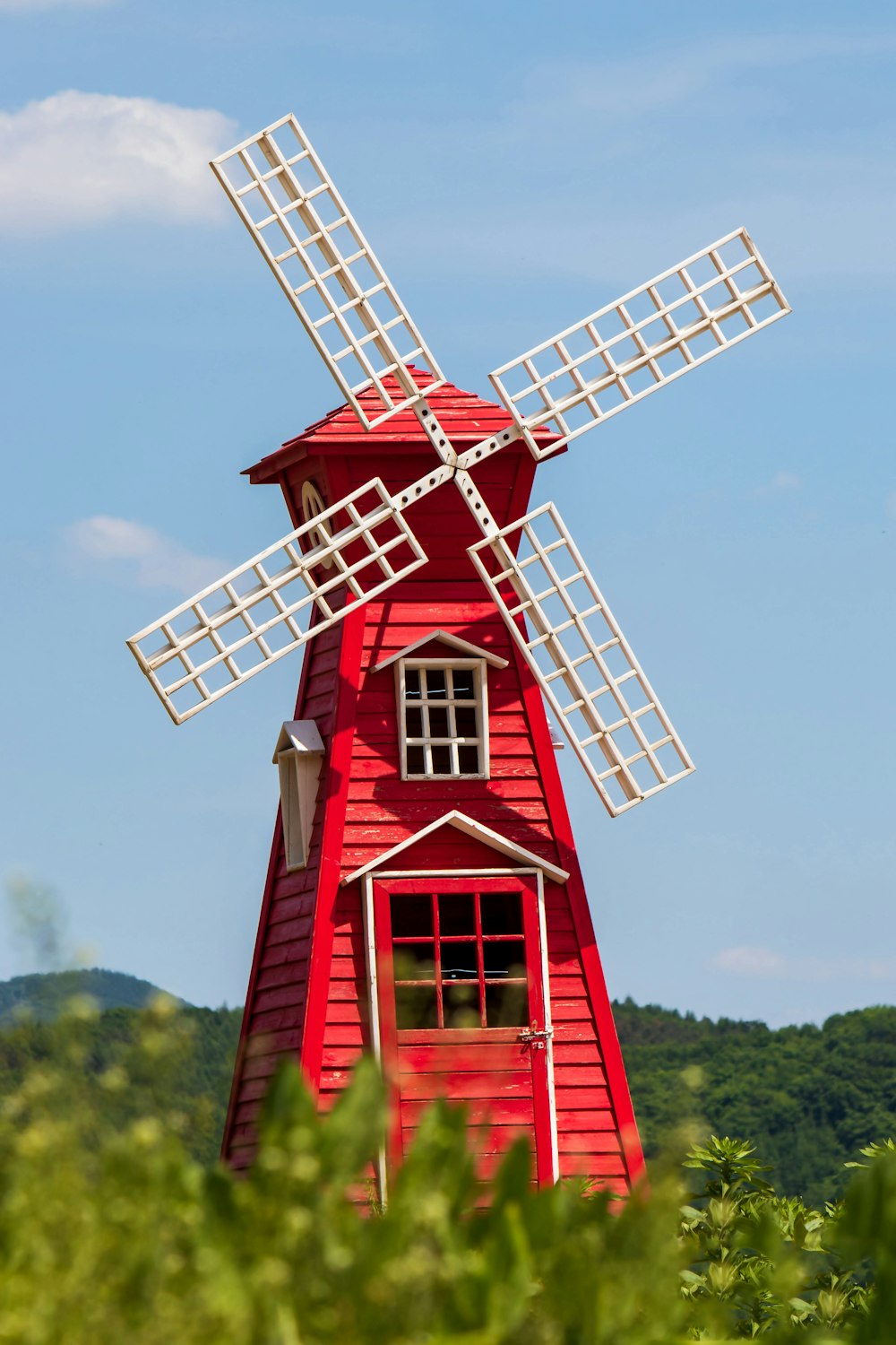 a red building with a windmill on top of it
