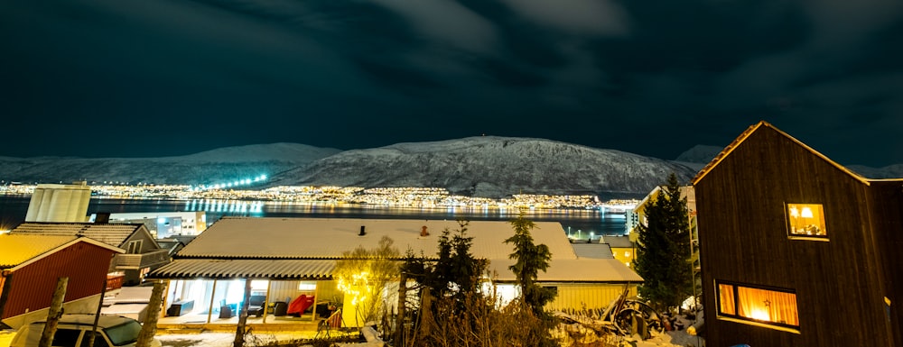 a night view of a town with a mountain in the background