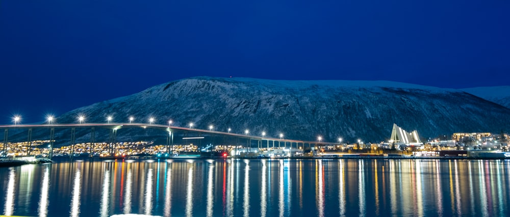 a night view of a city and a bridge over a body of water