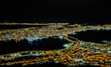 Night view of a city skyline illuminated with digital connectivity lines symbolizing global networks