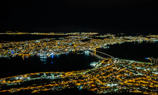 Night view of a city skyline illuminated with digital connectivity lines symbolizing global networks