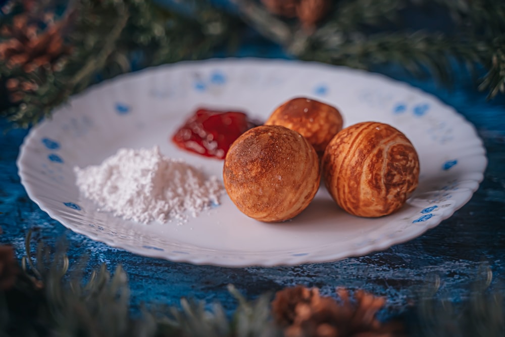 a white plate topped with three pastries on top of a table