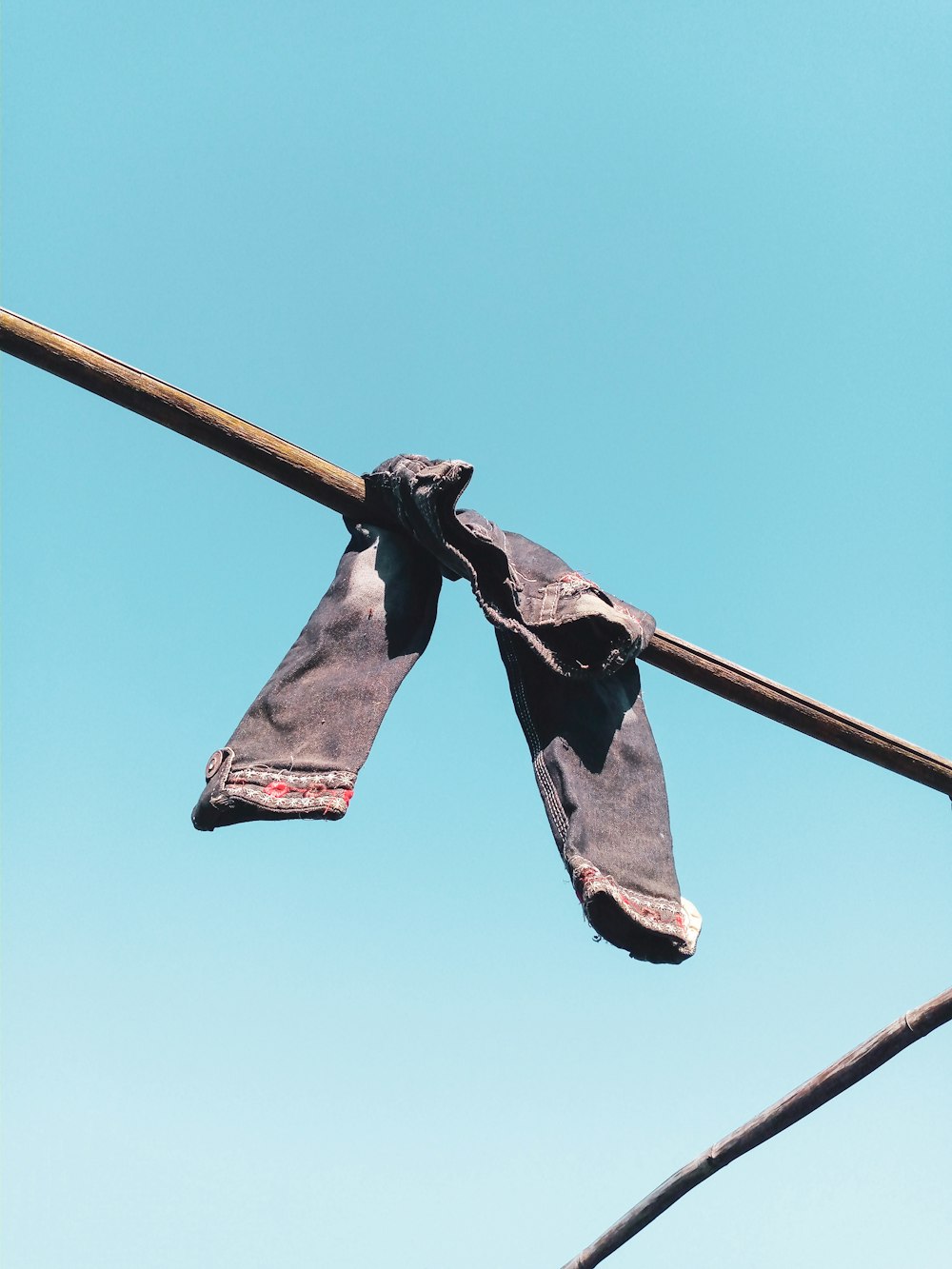 a pair of ties hanging from a clothes line