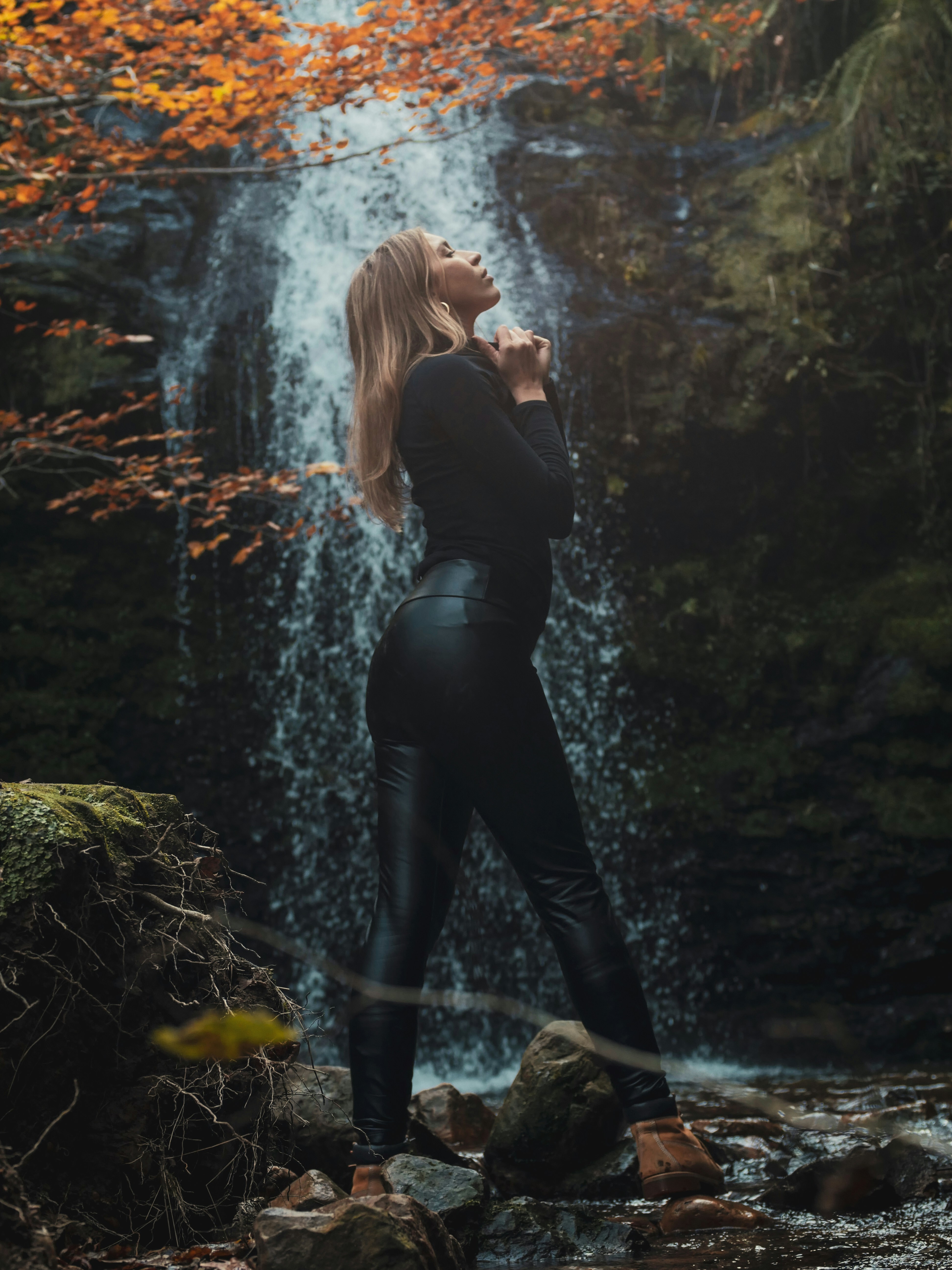 A woman standing in front of a waterfall photo – Free Water Image on ...