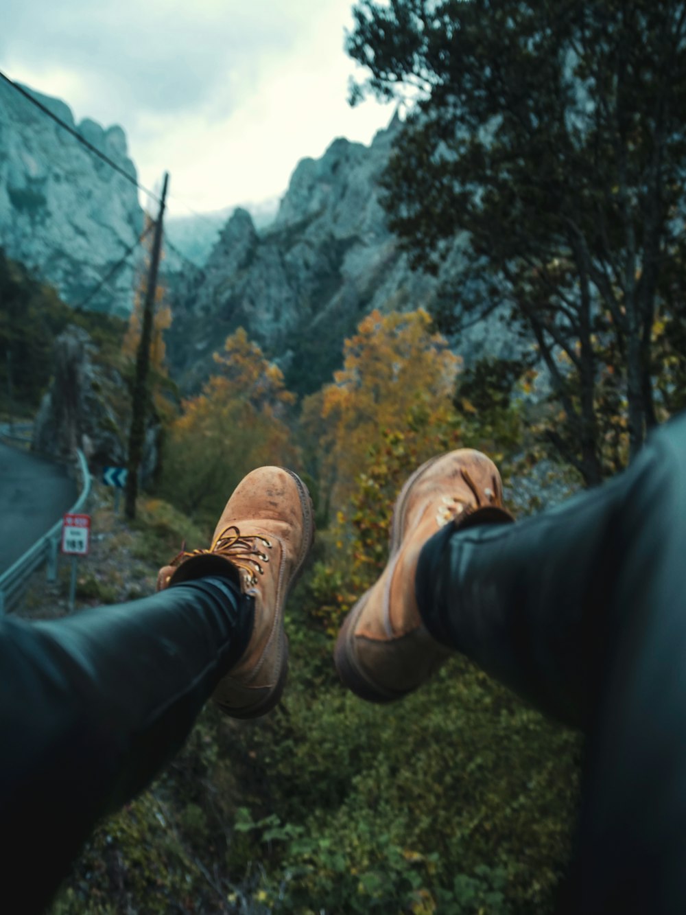 a pair of brown shoes standing on top of a mountain