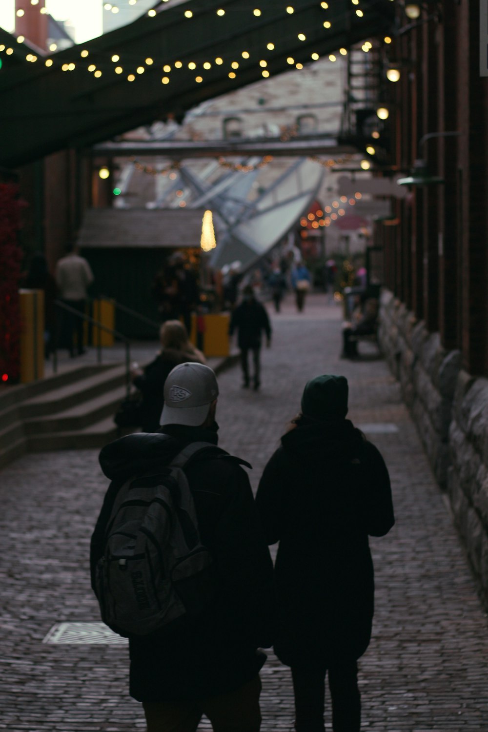 a couple of people walking down a street