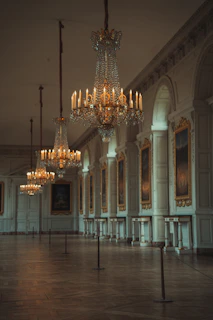 A beautifully cleaned royal palace hallway with shining marble floors and elegant chandeliers.