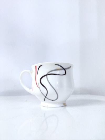 Sleek stainless steel Design Cup with floral sublimation print, resting on a pastel background.