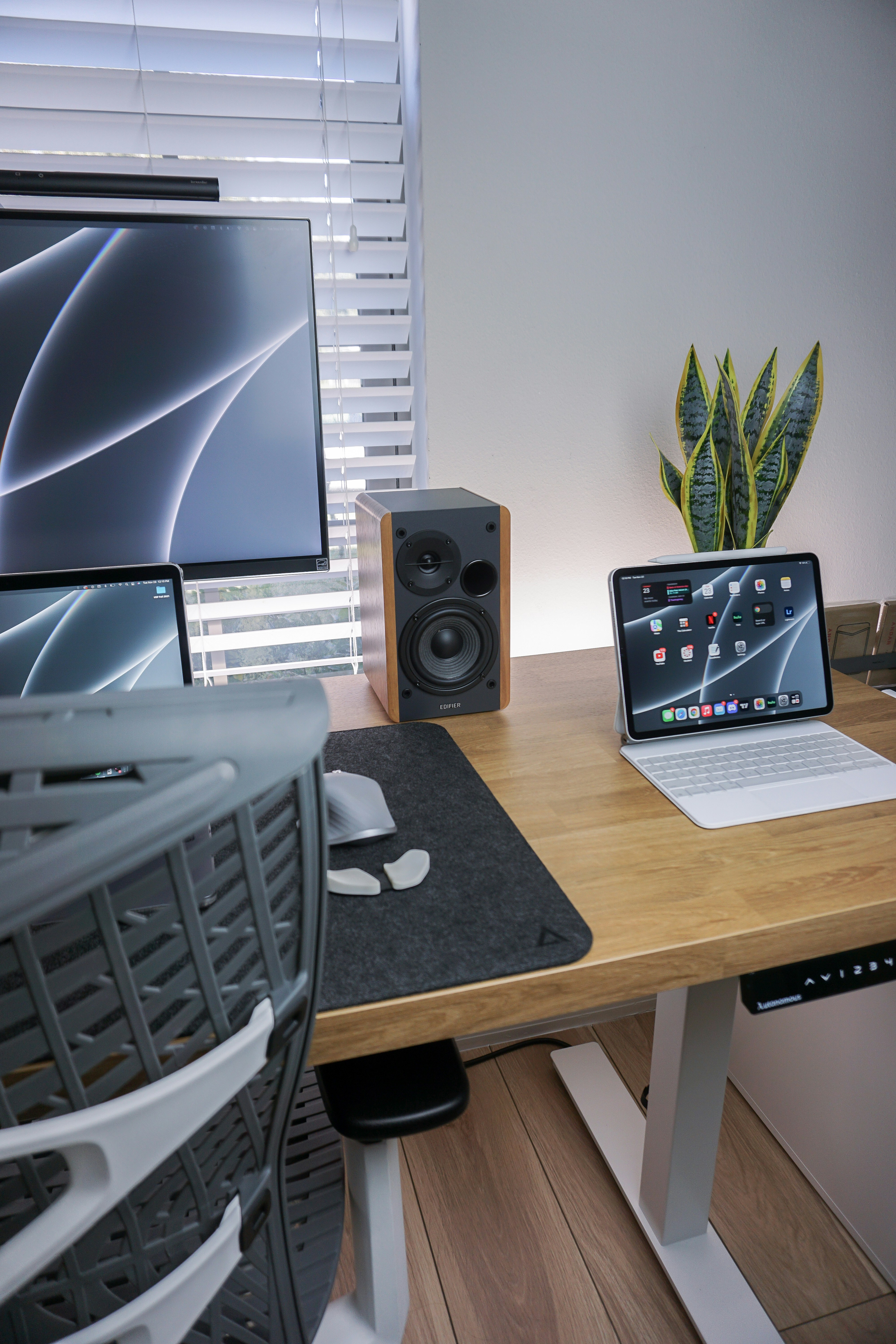 a laptop computer sitting on top of a wooden desk