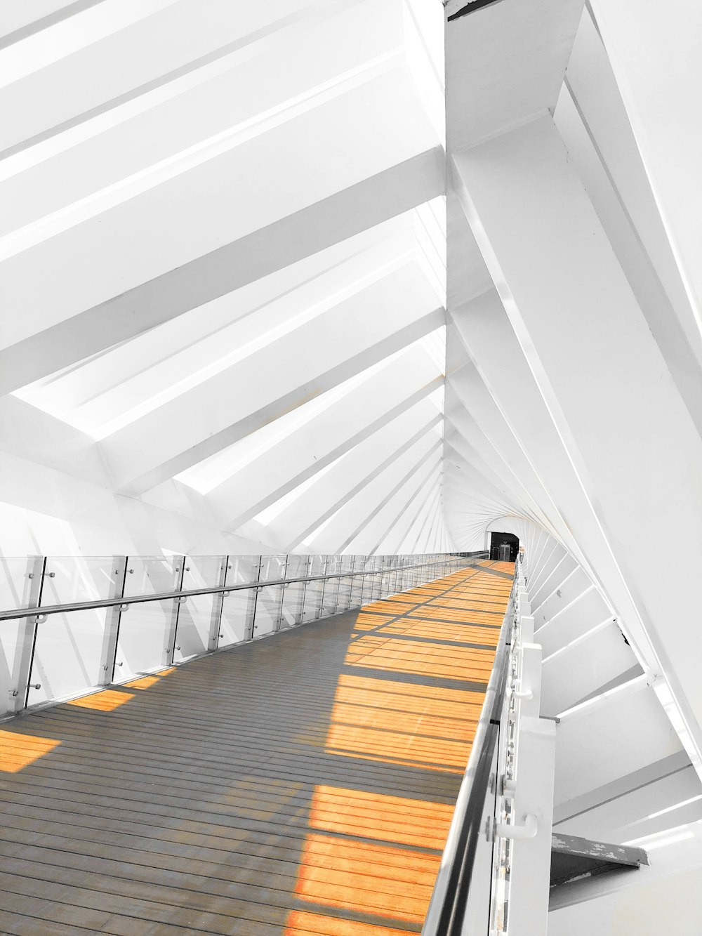 a white building with a long wooden walkway