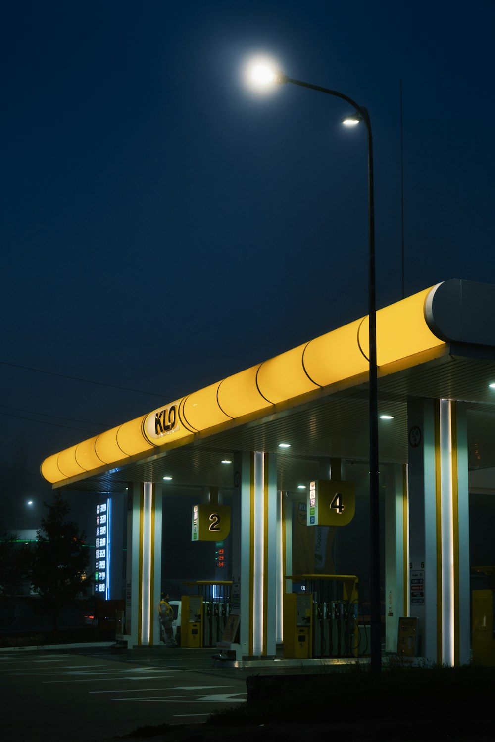 a gas station at night with lights on