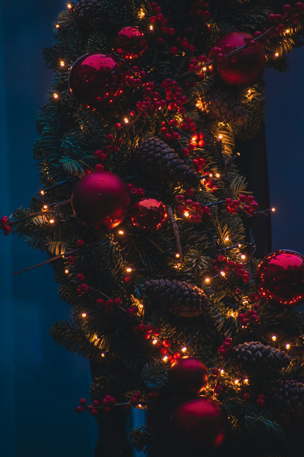 a christmas tree with red ornaments and lights