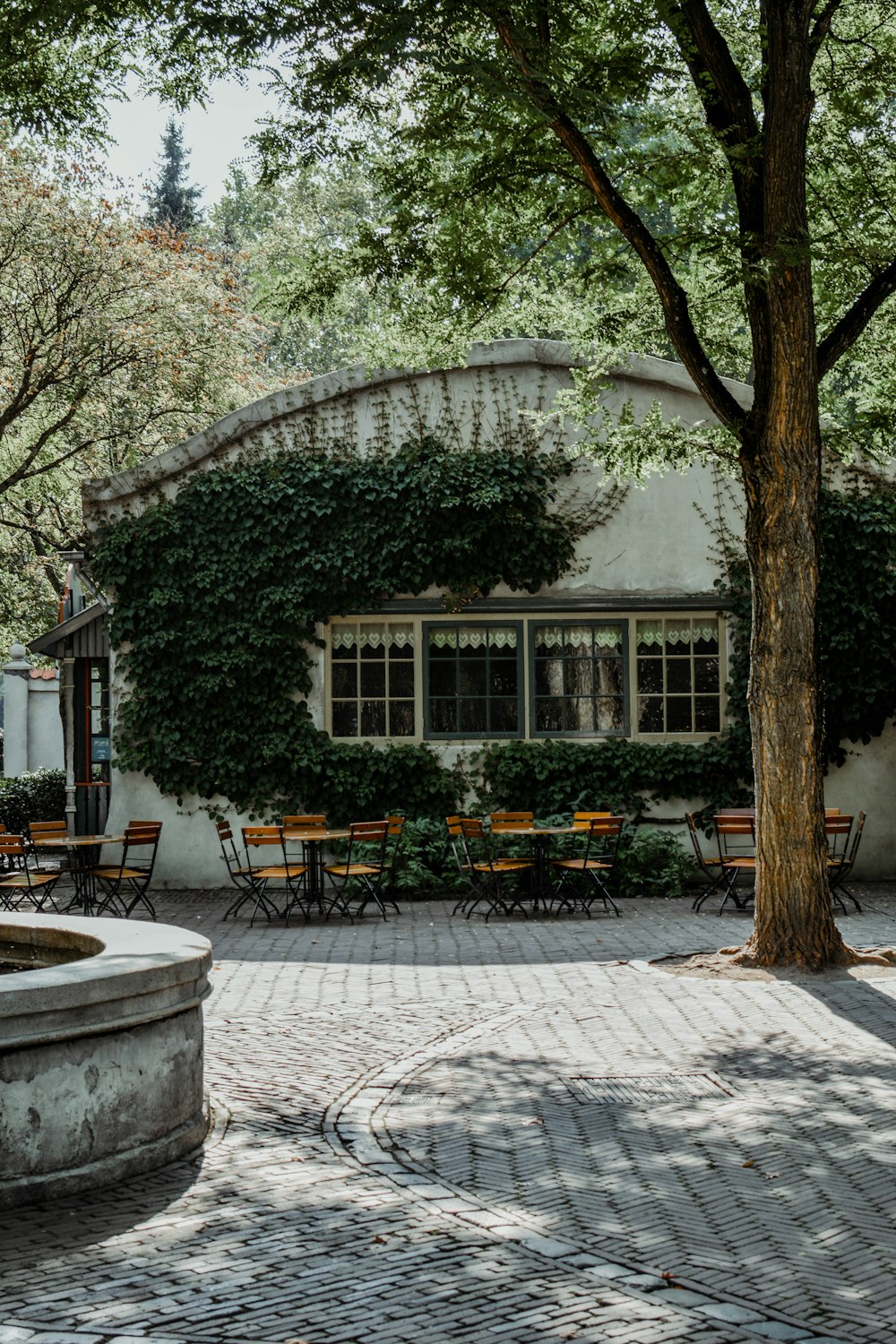 a courtyard with tables and chairs and a fountain