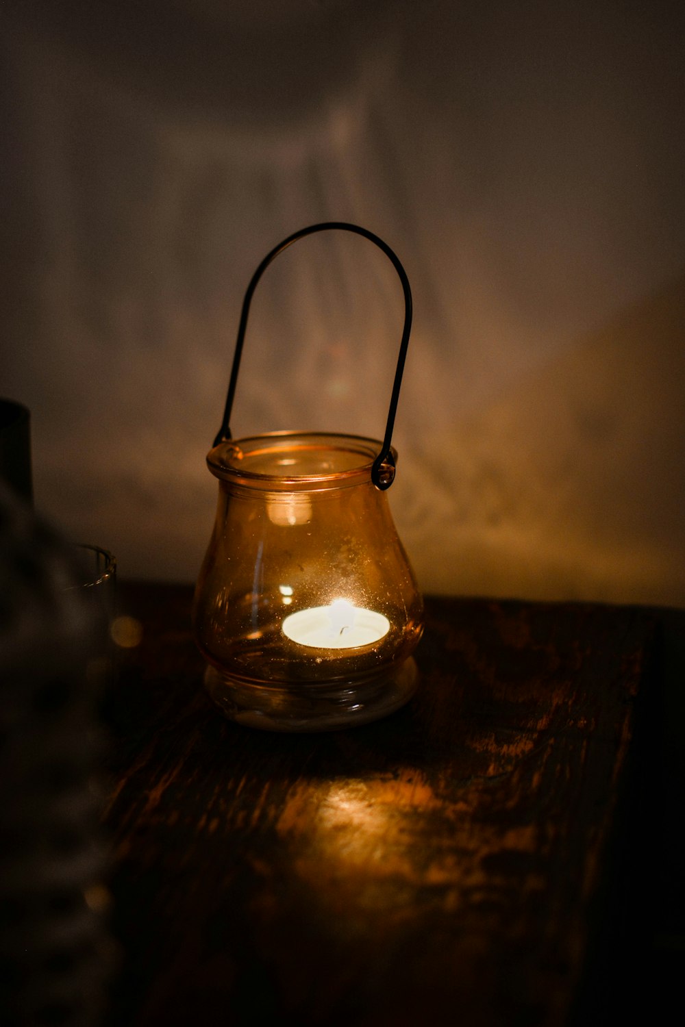 a lit candle is sitting on a table