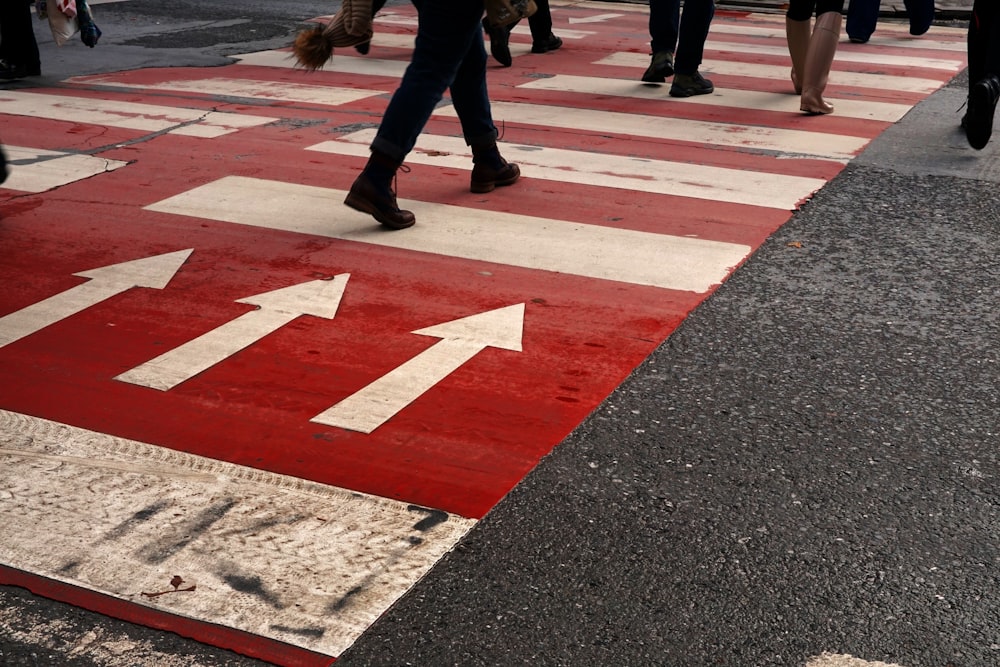 a group of people walking across a cross walk