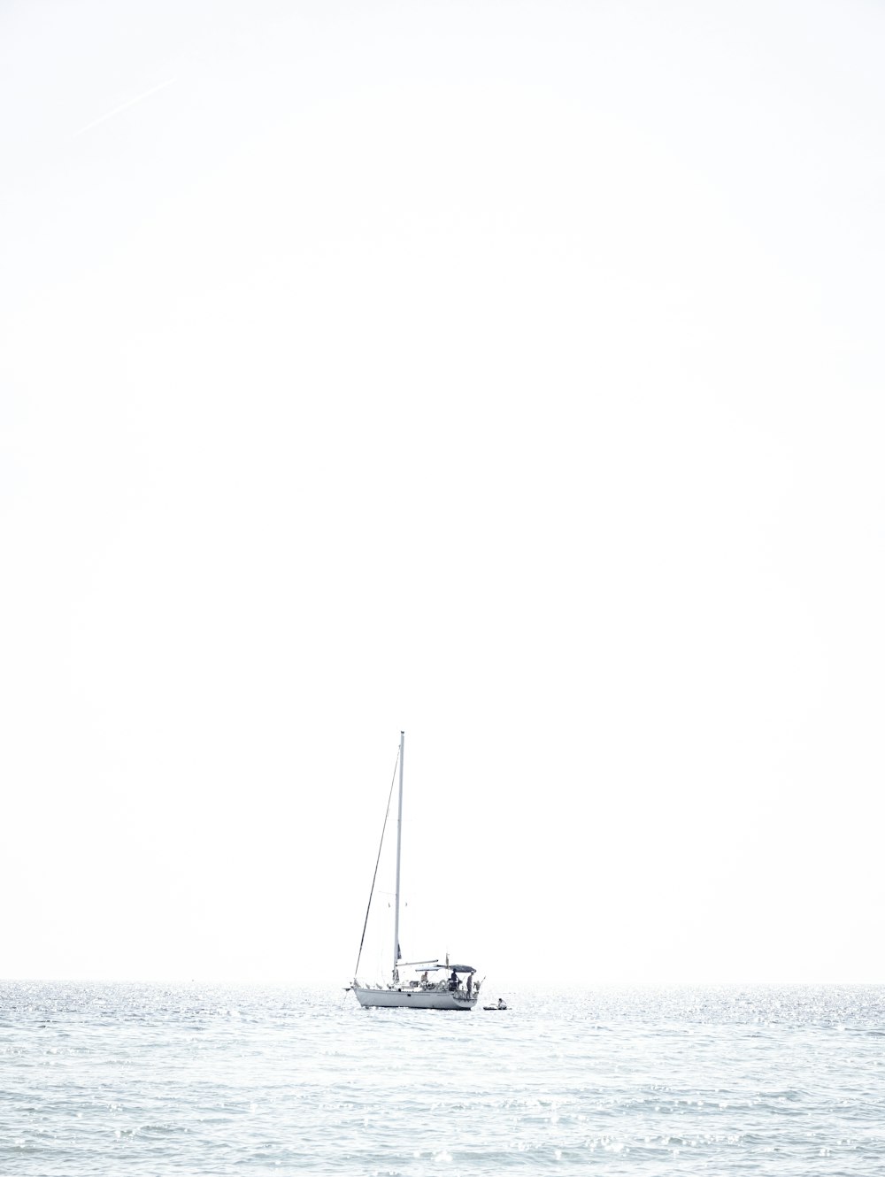 a sailboat in the middle of the ocean