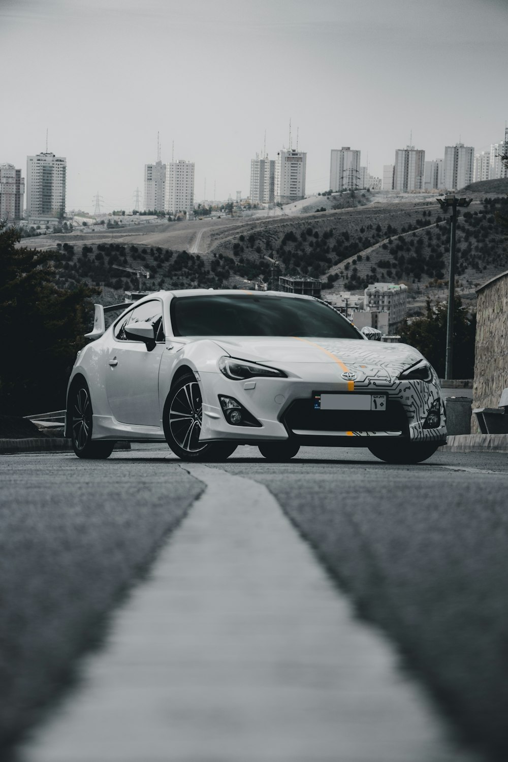 a white sports car parked on the side of the road