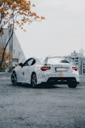 a white sports car parked in a parking lot