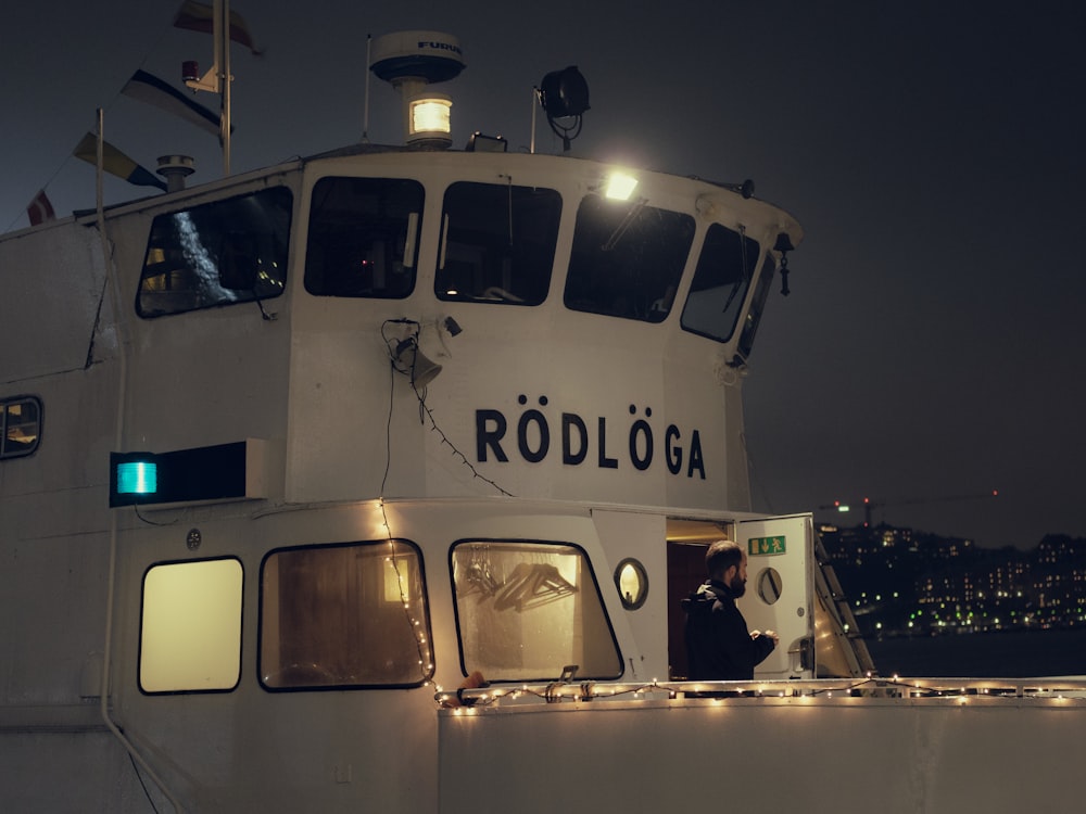 a white boat with lights on the side of it