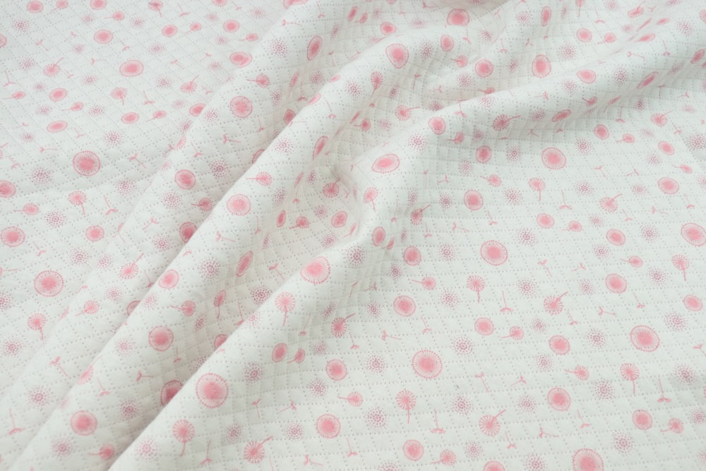 a close up of a pink and white polka dot fabric